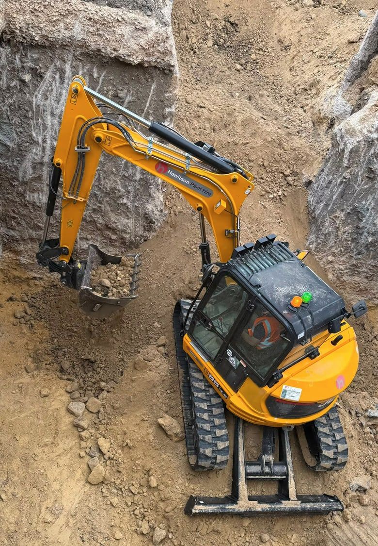 Excavator working in a trench